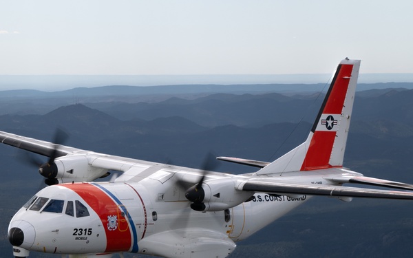 U.S. Coast Guard aircraft soar over Mount Rushmore