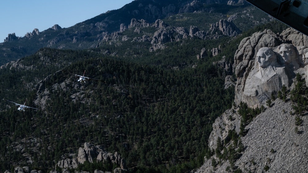 U.S. Coast Guard aircraft soar over Mount Rushmore
