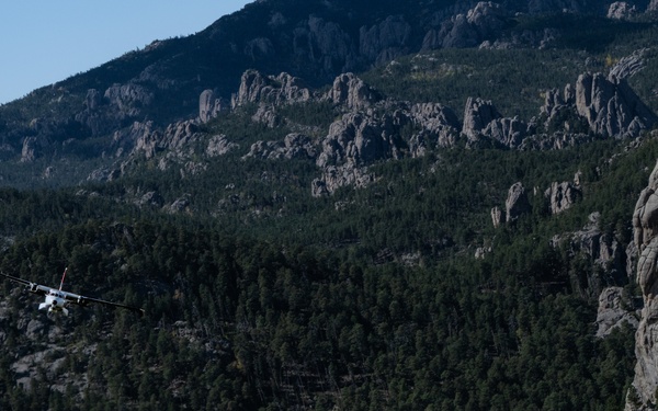 U.S. Coast Guard aircraft soar over Mount Rushmore