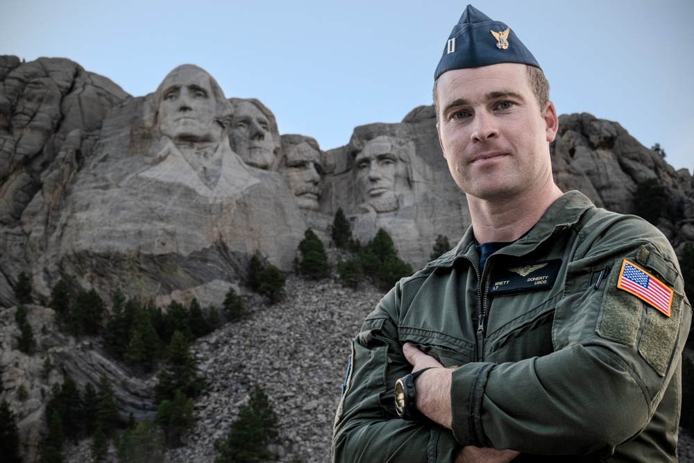 U.S. Coast Guard aircraft soar over Mount Rushmore
