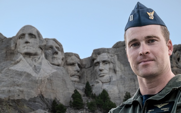 U.S. Coast Guard aircraft soar over Mount Rushmore