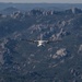 U.S. Coast Guard aircraft soar over Mount Rushmore