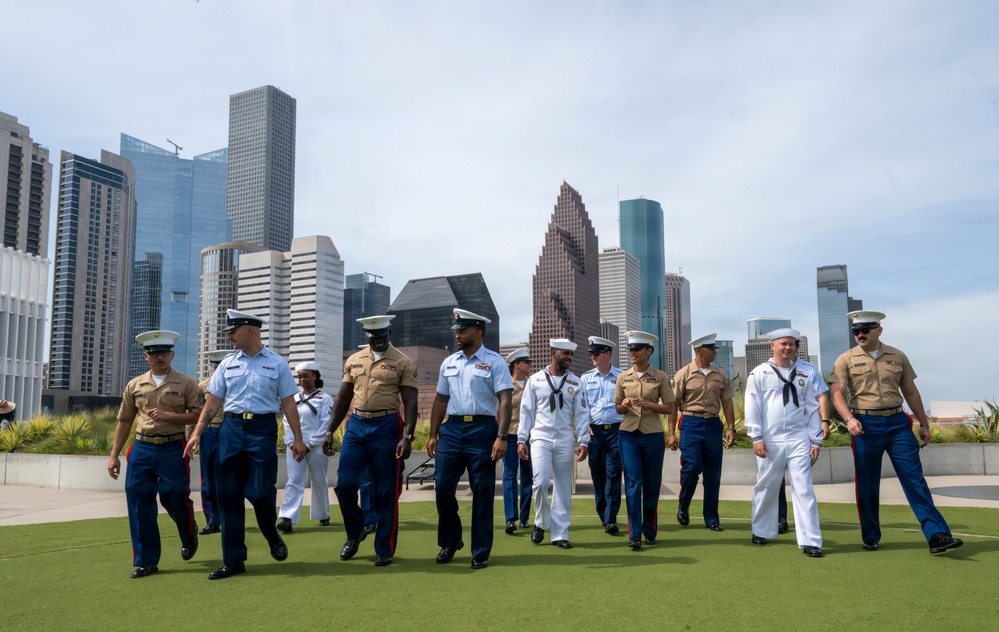 Service members from all branches walk together for Fleet Week promotion