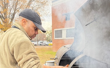 Army Culinary specialist prepares Cornish hens for Thanksgiving meal