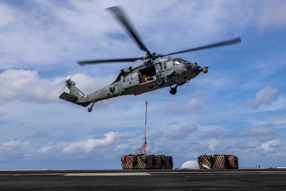 Abraham Lincoln conducts a replenishment-at-sea with the Henry J. Kaiser