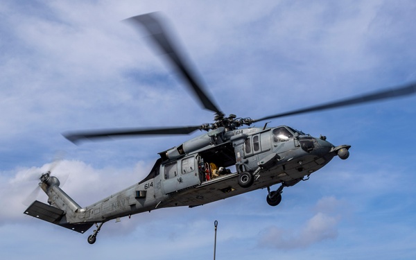 Abraham Lincoln conducts a replenishment-at-sea with the Henry J. Kaiser