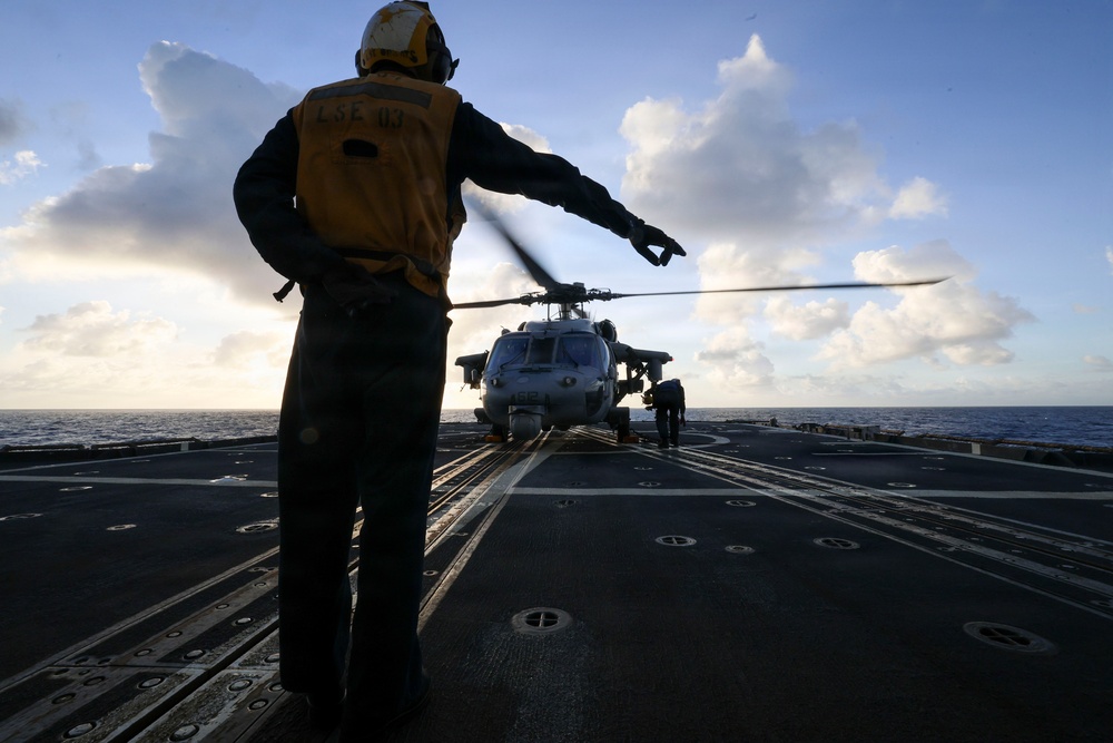 U.S. Sailor Signals an Mh-60R Seahawk Helicopter
