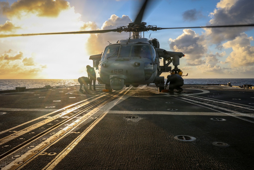 U.S. Sailors Chock and Chain an MH-60R Sea Hawk Helicopter