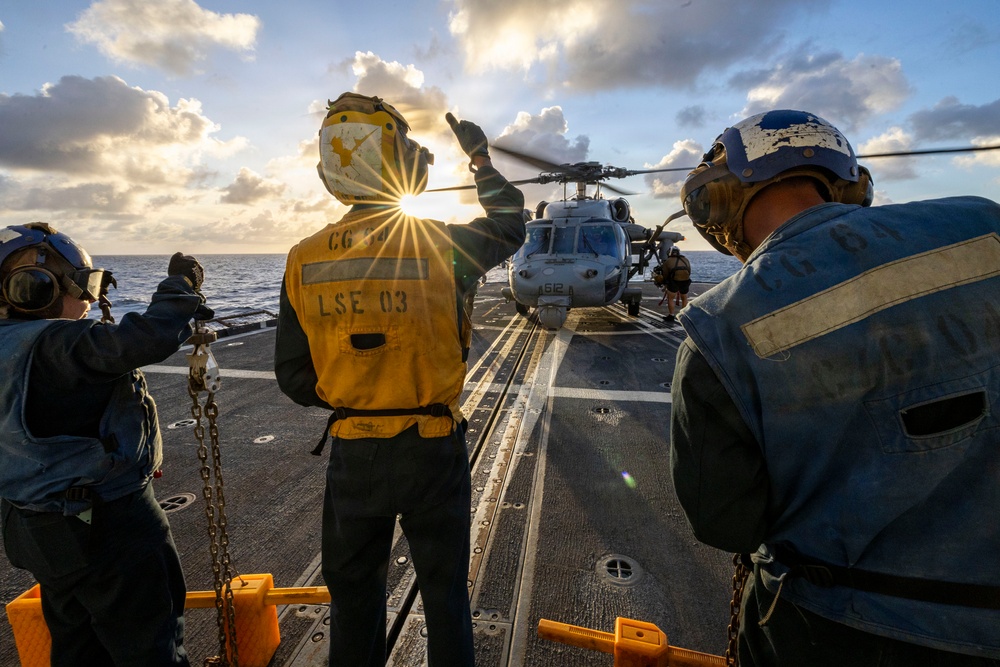 U.S. Sailors Present Chock and Chain to an MH-60R Sea Hawk Helicopter