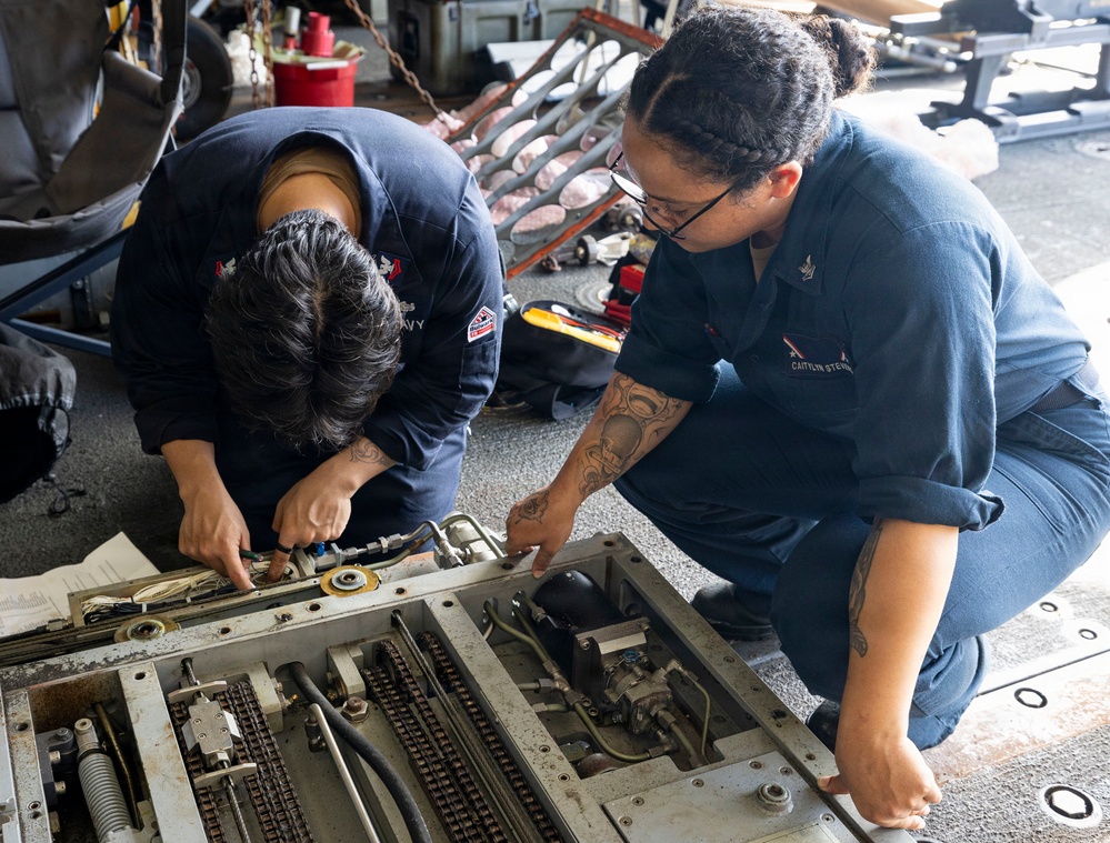 U.S. Sailors Conduct Routine Maintenance of a Rapid Securing Device in the Hangar Bay