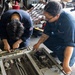 U.S. Sailors Conduct Routine Maintenance of a Rapid Securing Device in the Hangar Bay