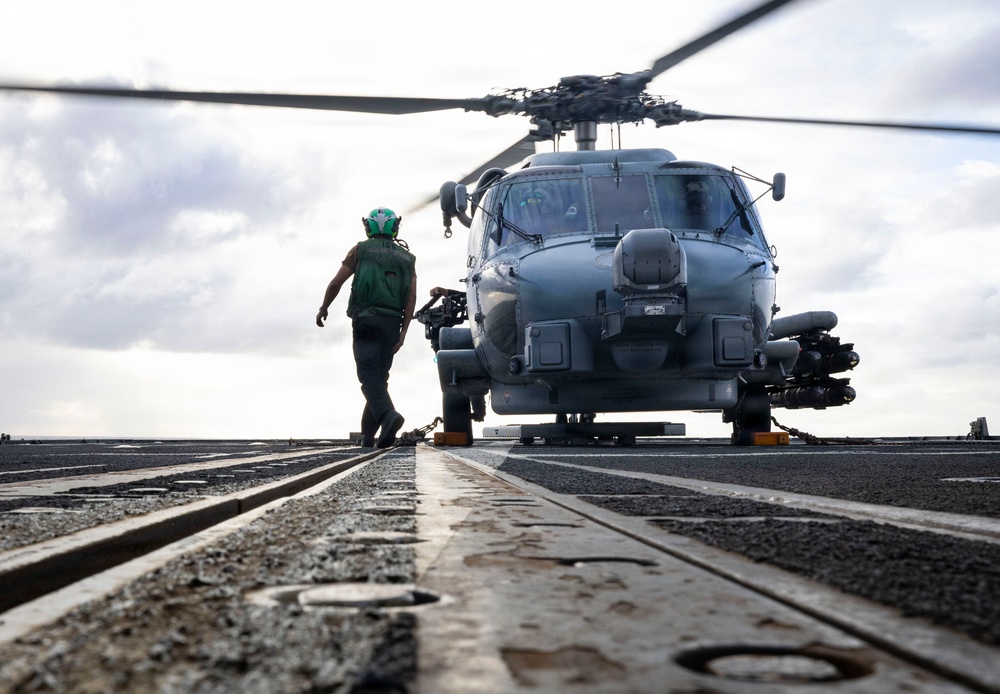 U.S. Sailors Prepare to Chock and Chain an MH-60R Sea Hawk Helicopter