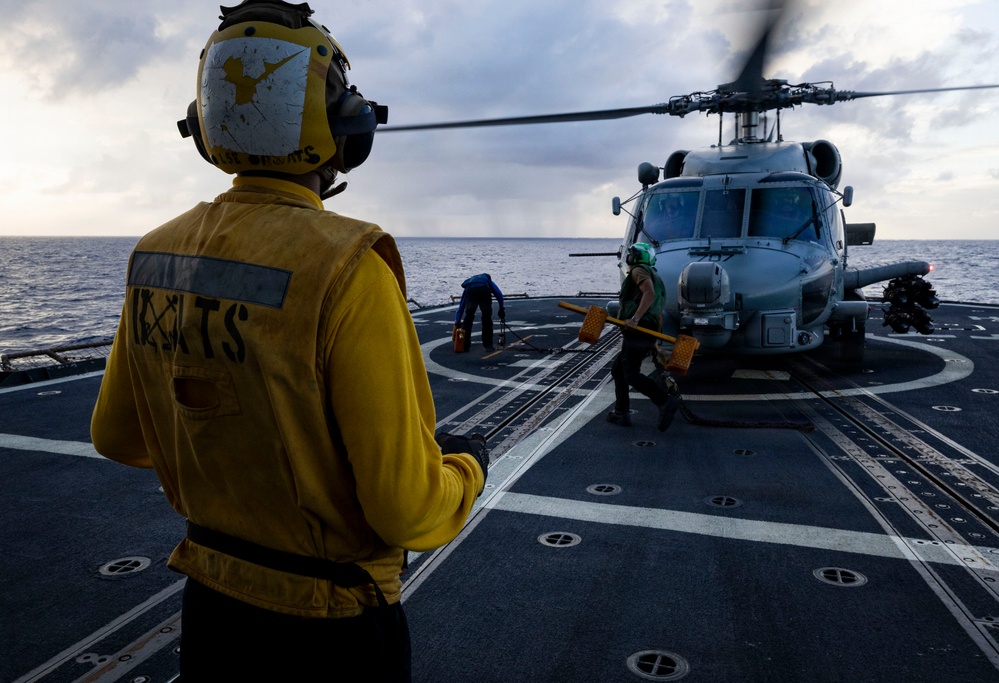 U.S. Sailors Remove Chocks and Chains From an MH-60R Sea Hawk Helicopter