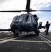 A U.S. Sailor Removes Chocks and Chains From a U.S. Air Force HH-60W Pave Hawk Helicopter on the Flight Deck