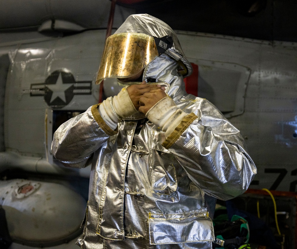 U.S. Sailor Dons Fire Proximity Gear in the Hangar Bay