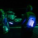 A U.S. Sailor Signals an MH-60R Sea Hawk, Attached to Helicopter Maritime Squadron 72