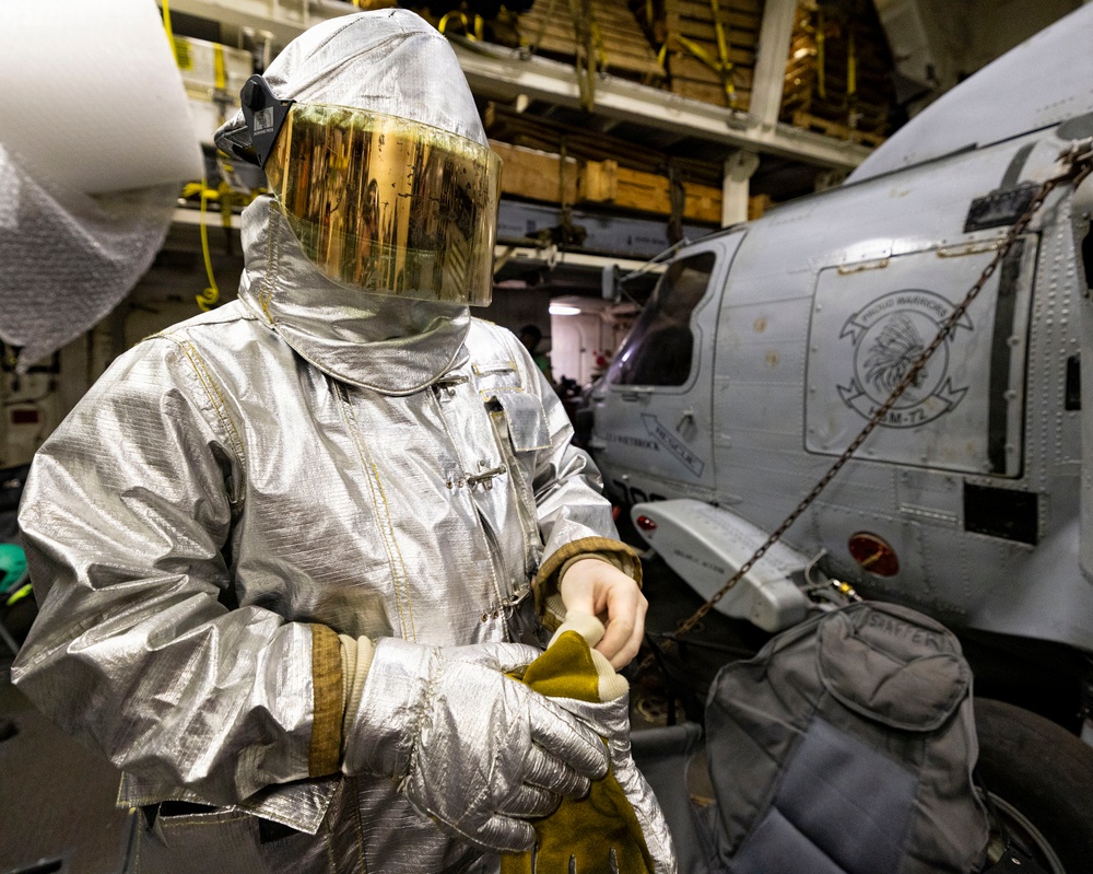 U.S. Sailor Dons Fire Proximity Gear in the Hangar Bay