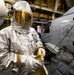 U.S. Sailor Dons Fire Proximity Gear in the Hangar Bay