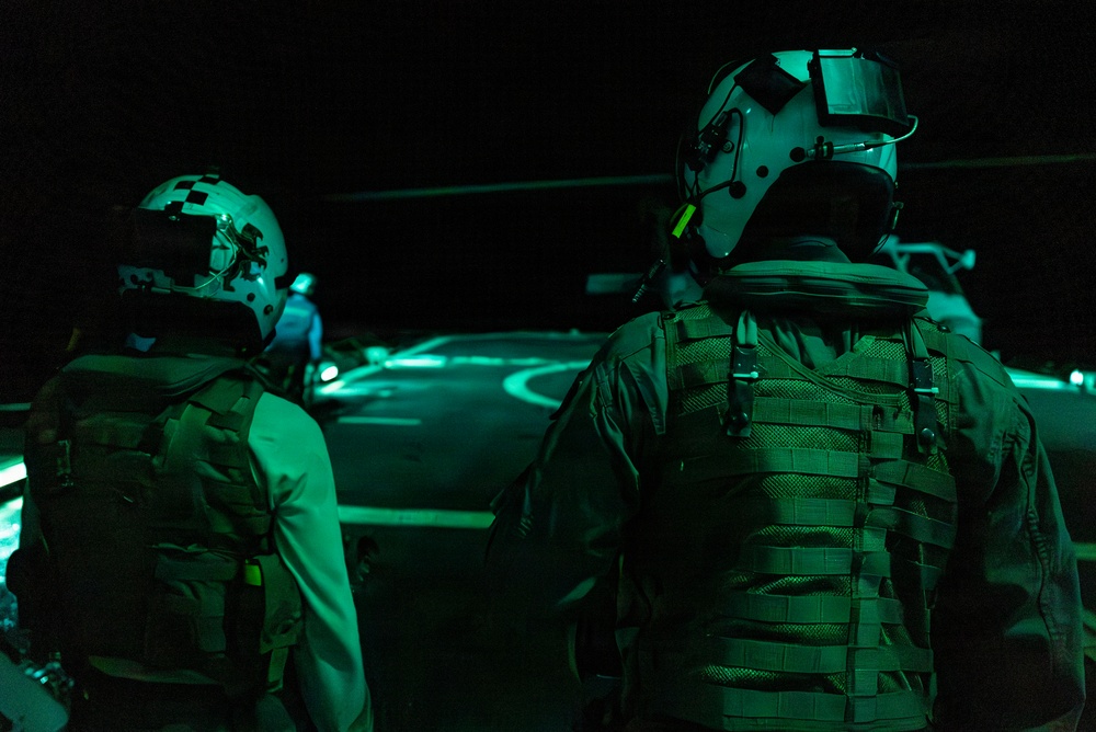 U.S. Sailors Prepare to Embark an MH-60R Sea Hawk, Attached to Helicopter Maritime Squadron 72