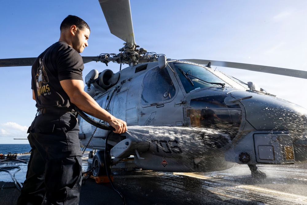 U.S. Sailor Washes an MH-60R Sea Hawk Helicopter