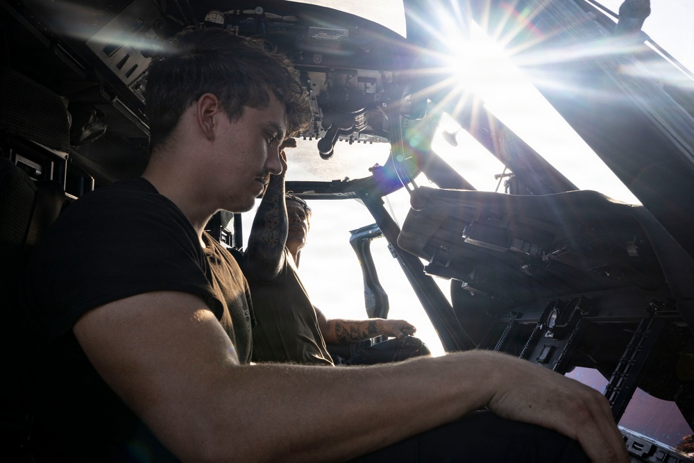 U.S. Sailors Conduct Routine Maintenance of an MH-60R Sea Hawk Helicopter on the Flight Deck