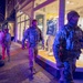 Mississippi National Guard service members walk past a store at night in Washington, D.C.