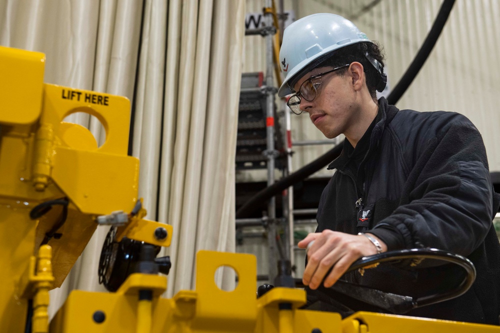 Ronald Reagan Sailors Charge Electronically Enclosed Forklift