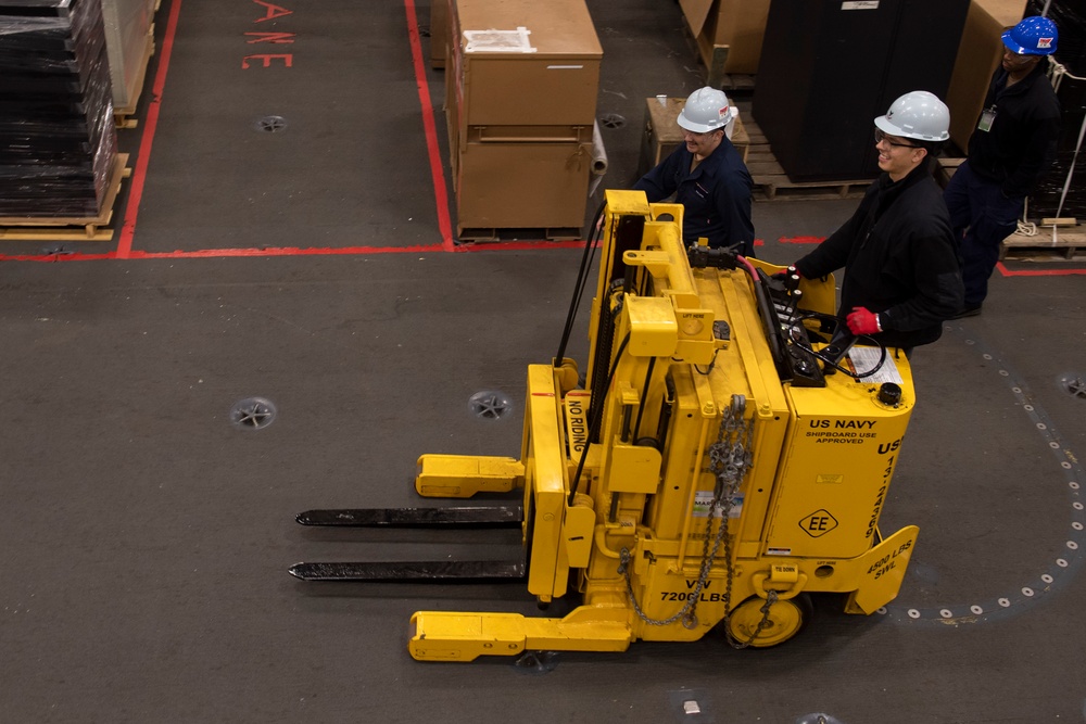 Ronald Reagan Sailors Charge Electronically Enclosed Forklift