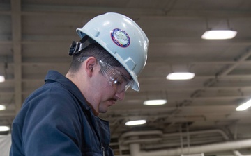 Ronald Reagan Sailors Charge Electronically Enclosed Forklift