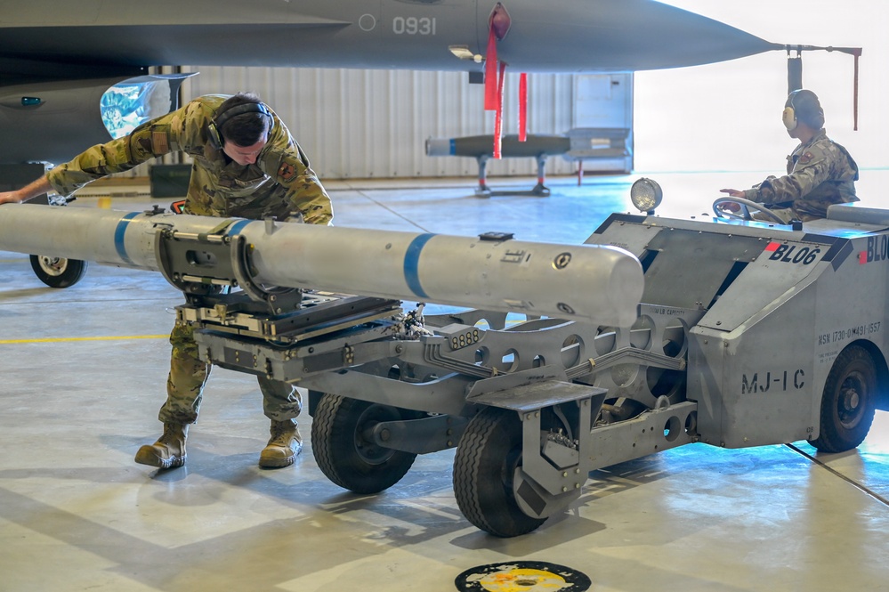 849th Aircraft Maintenance Squadron Airmen load weapons onto F-16 Fighting Falcons during monthly training