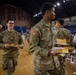 Mississippi Army National Guard Soldiers walk back to their table to eat during a holiday luncheon