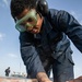 USS Mitscher (DDG 57) Sailor conducts deck preservation