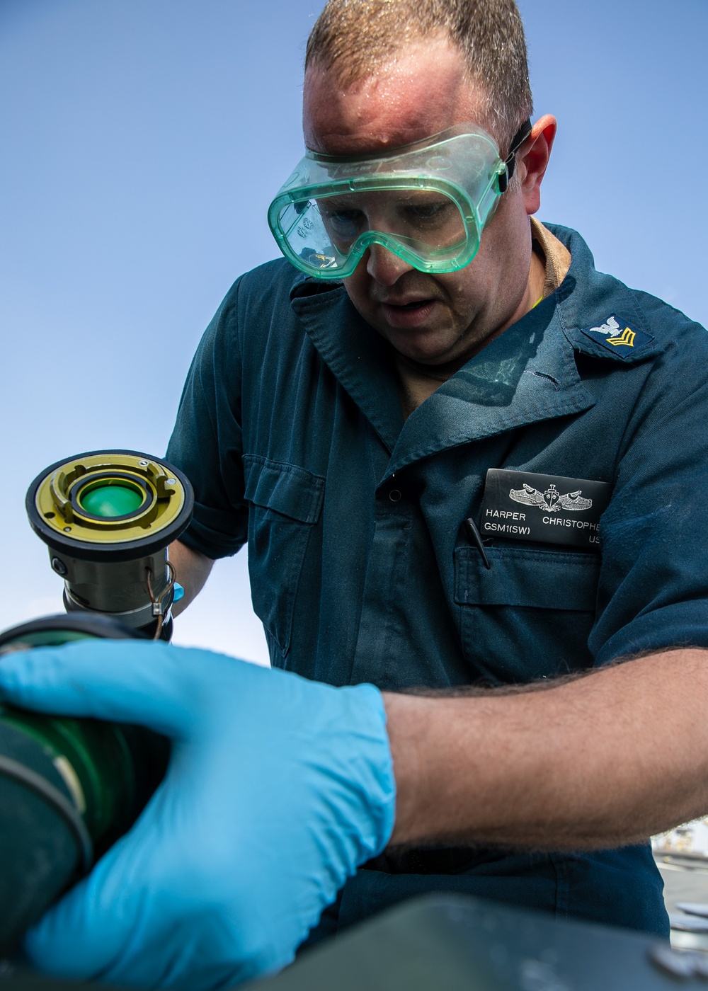USS Mitscher (DDG 57) Sailor tests refueling connector