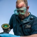 USS Mitscher (DDG 57) Sailor tests refueling connector