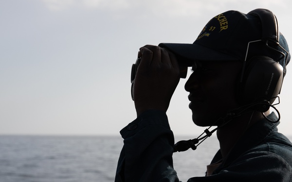 USS Mitscher (DDG 57) Sailor stands aft lookout watch on flight deck