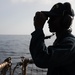 USS Mitscher (DDG 57) Sailor stands aft lookout watch on flight deck
