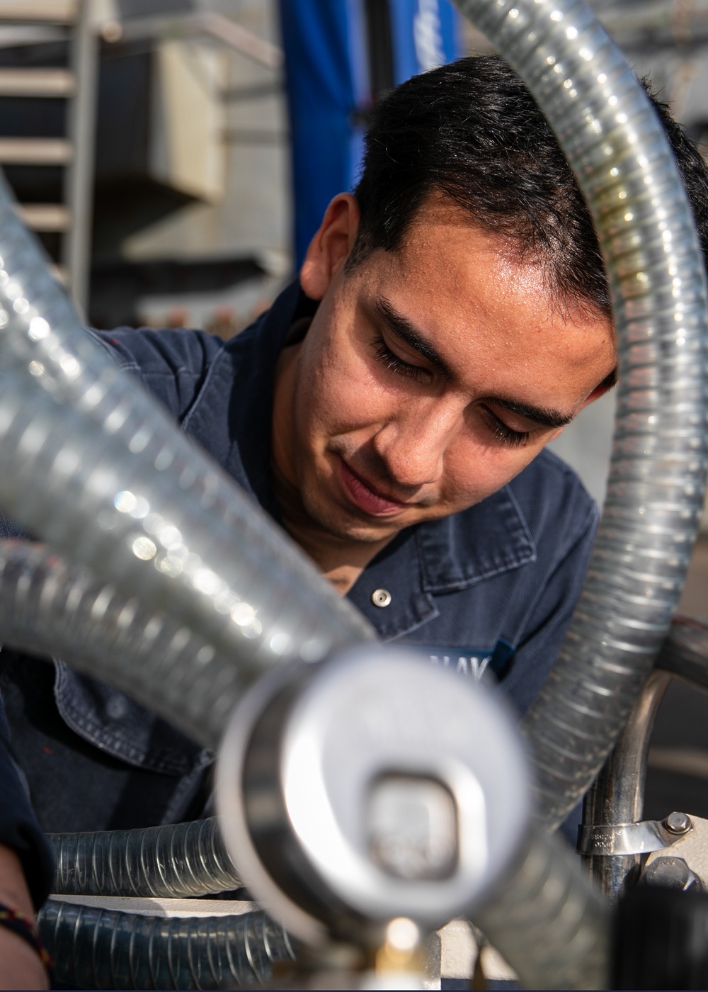 USS Mitscher (DDG 57) Sailor conducts maintenance on LPAD