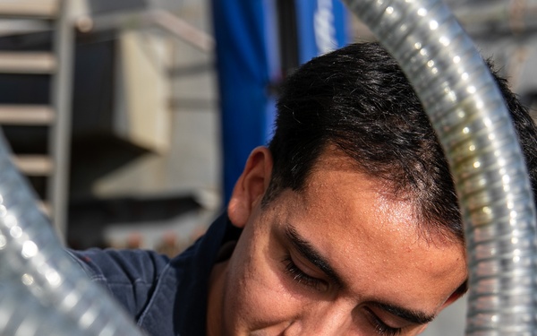 USS Mitscher (DDG 57) Sailor conducts maintenance on LPAD