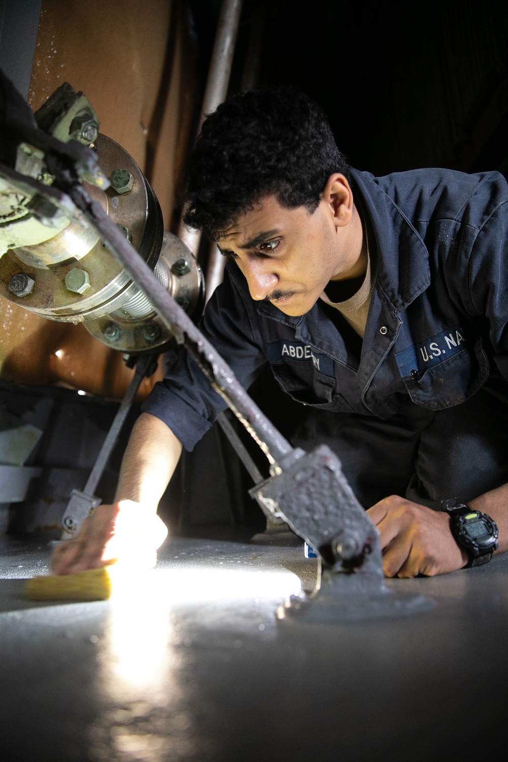 USS Mitscher (DDG 57) Sailor conducts air intake maintenance