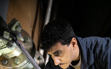 USS Mitscher (DDG 57) Sailor conducts air intake maintenance