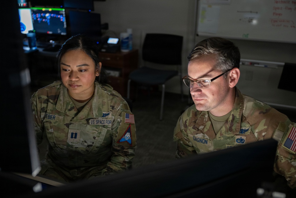 Space Force Guardians assigned to Space Delta 5 monitor a computer workstation.