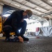 Theodore Roosevelt Sailor Cleans in Hangar Bay