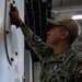 USS Theodore Roosevelt Sailor Cleans in Hangar Bay