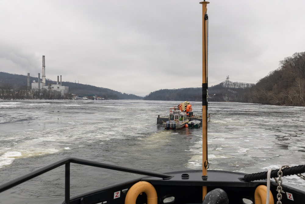 Coast Guard Cutter Cleat escorts a tug through semi-frozen waters.