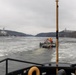 Coast Guard Cutter Cleat escorts a tug through semi-frozen waters.