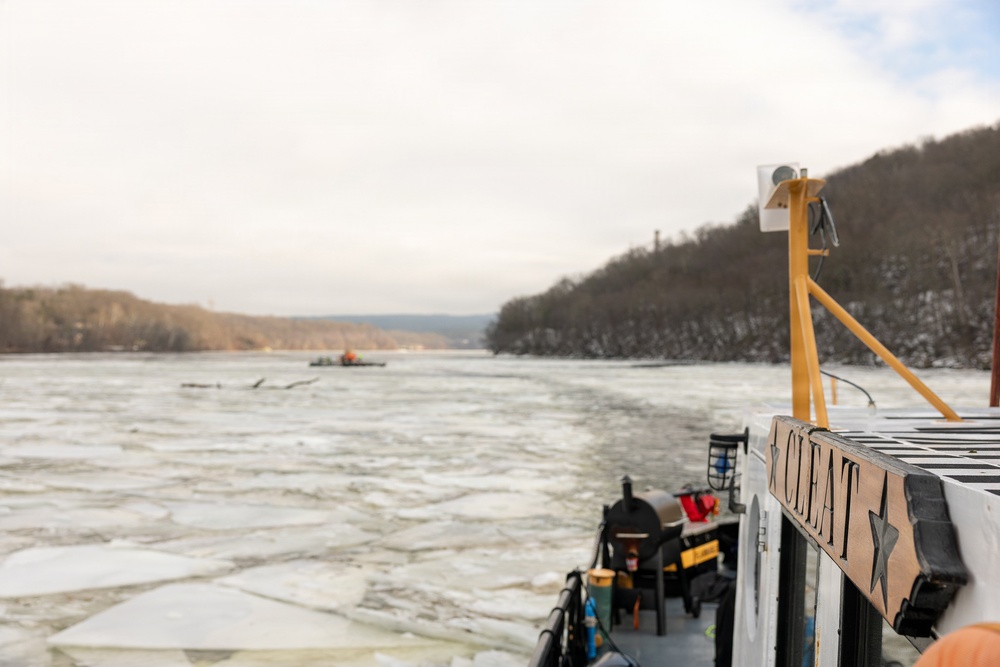 Coast Guard Cutter Cleat escorts a tug through semi-frozen waters.