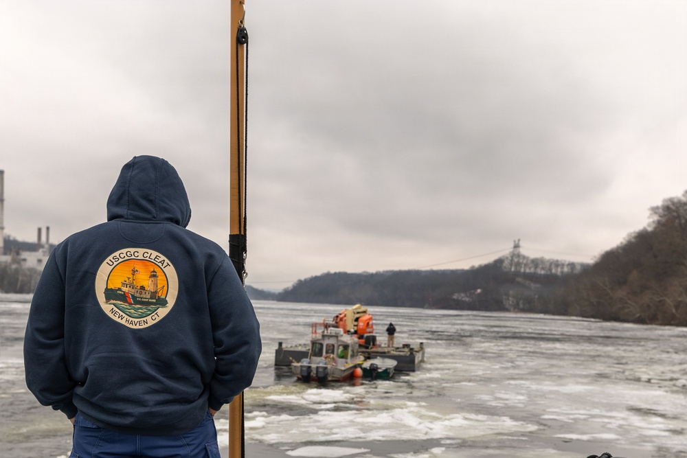 Coast Guard Cutter Cleat escorts a tug through semi-frozen waters.