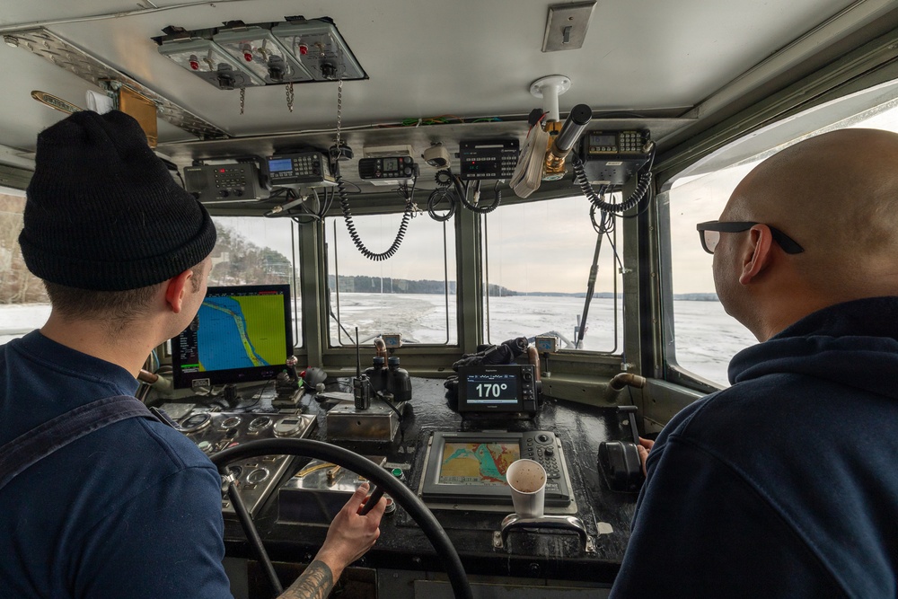 Coast Guard Cutter Cleat escorts a tug through semi-frozen waters.