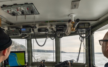 Coast Guard Cutter Cleat escorts a tug through semi-frozen waters.