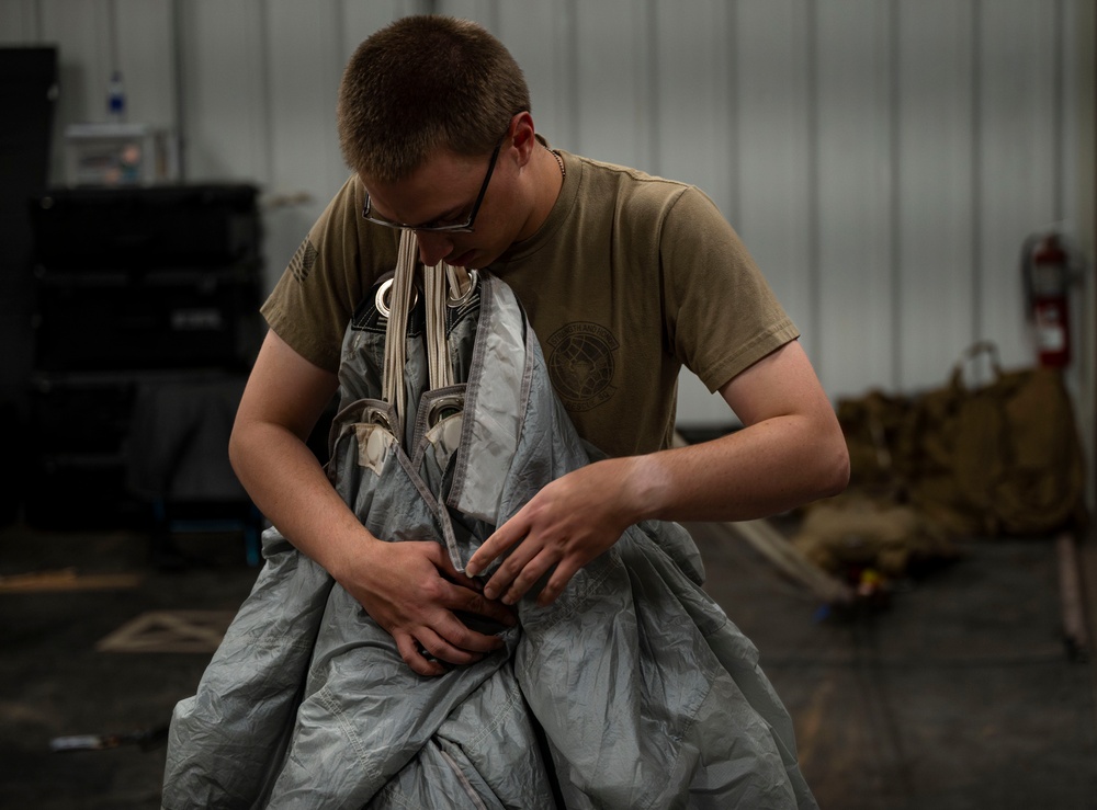 82nd ERQS Airman prepares parachutes for regional operations